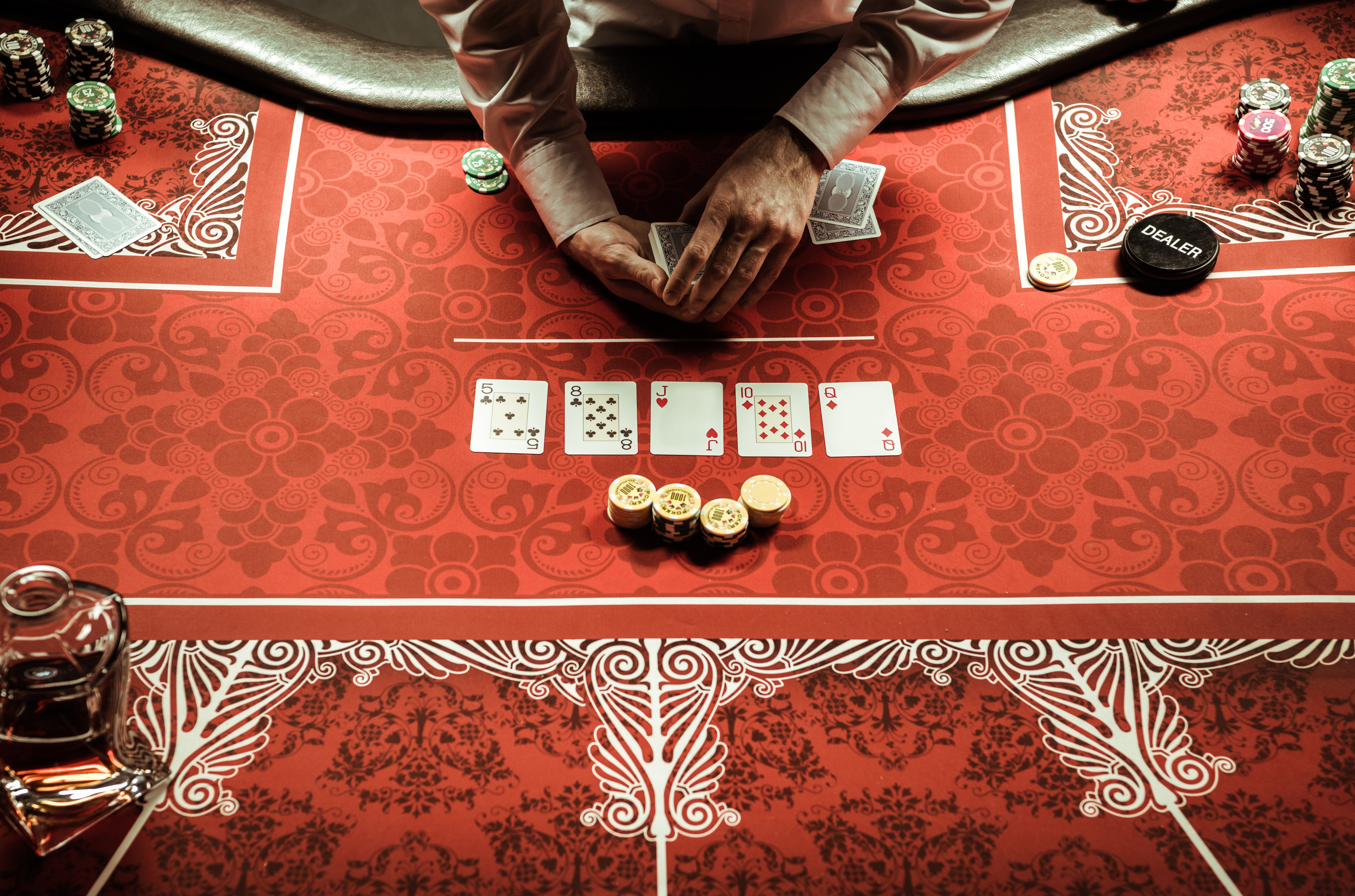 Dealer dealing cards at a poker table